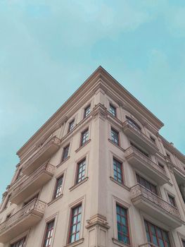 Elegant building in Mariupol with blue sky backdrop from a low angle perspective.