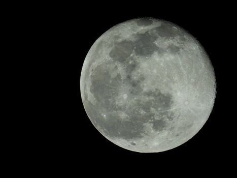 A detailed photograph of the full moon highlighting craters and lunar surface in the night sky.