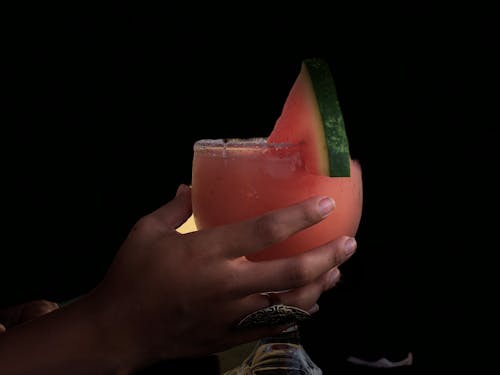 Person Holding Long-stem Glass With Watermelon Juice