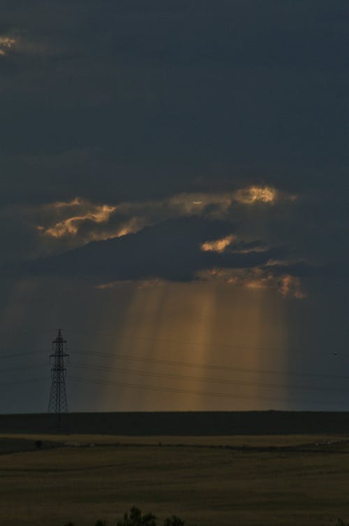 Crepuscular Rays from Blue Sky with Gray and White Clouds