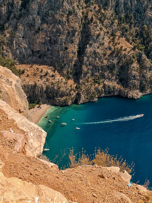Free Breathtaking aerial view of a turquoise beach cove surrounded by dramatic cliffs. Stock Photo