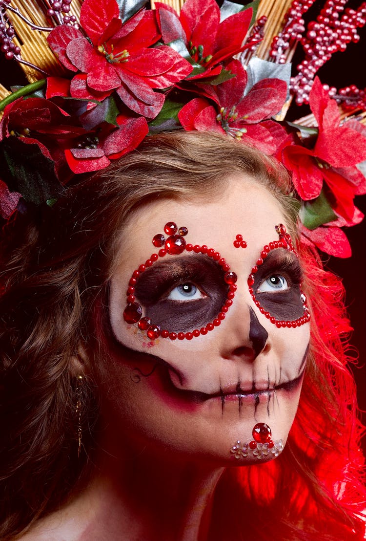 A Woman With Face Paint Wearing A Headdress