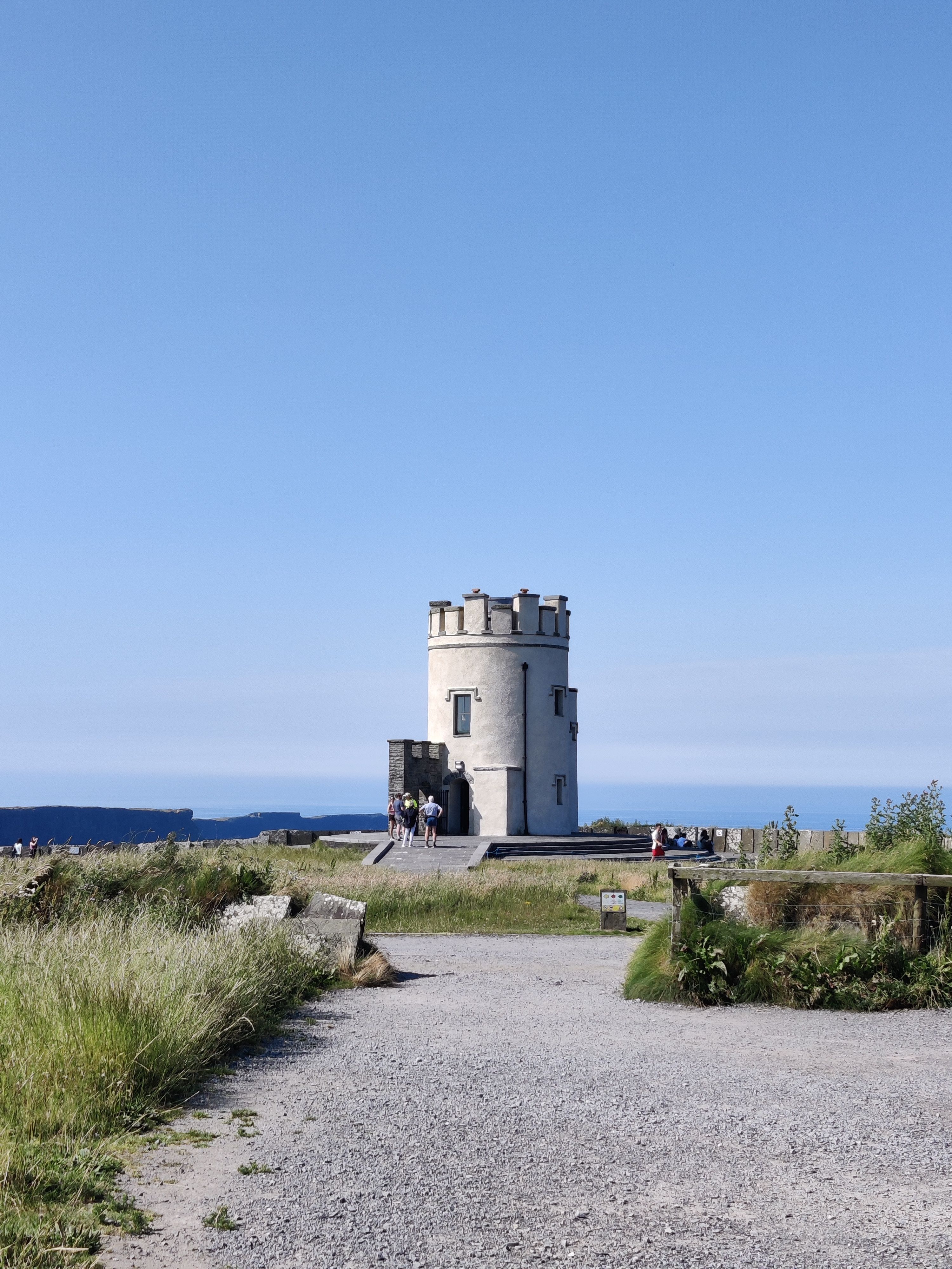 O'Brien's Tower on the Cliffs of Moher under a clear blue sky, showcasing Ireland's iconic landmark.