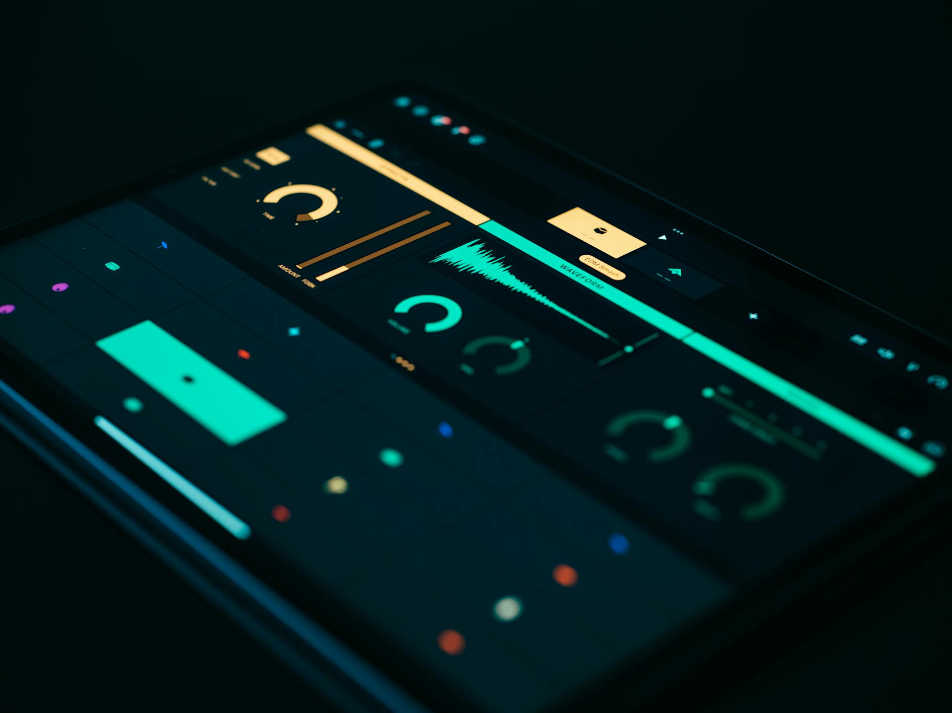 Close-up of a tablet screen displaying a sound visualizer with modern UI elements on a black background.