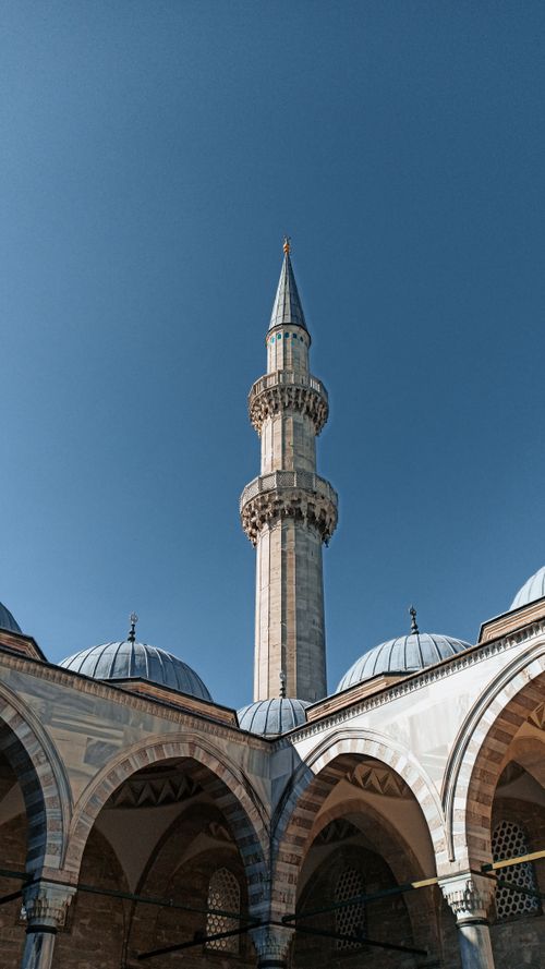 Free A low angle view of a stunning minaret in Istanbul, Turkey against a vibrant blue sky. Stock Photo