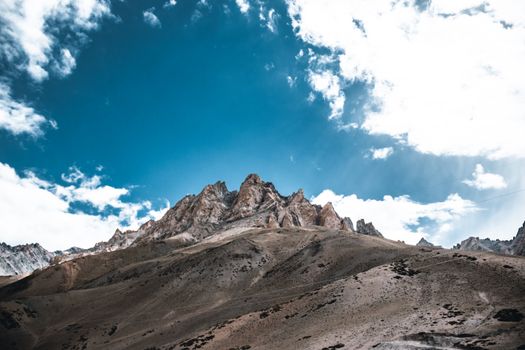 Stunning landscape featuring rugged mountain peaks against a clear blue sky, perfect for nature and adventure themes.