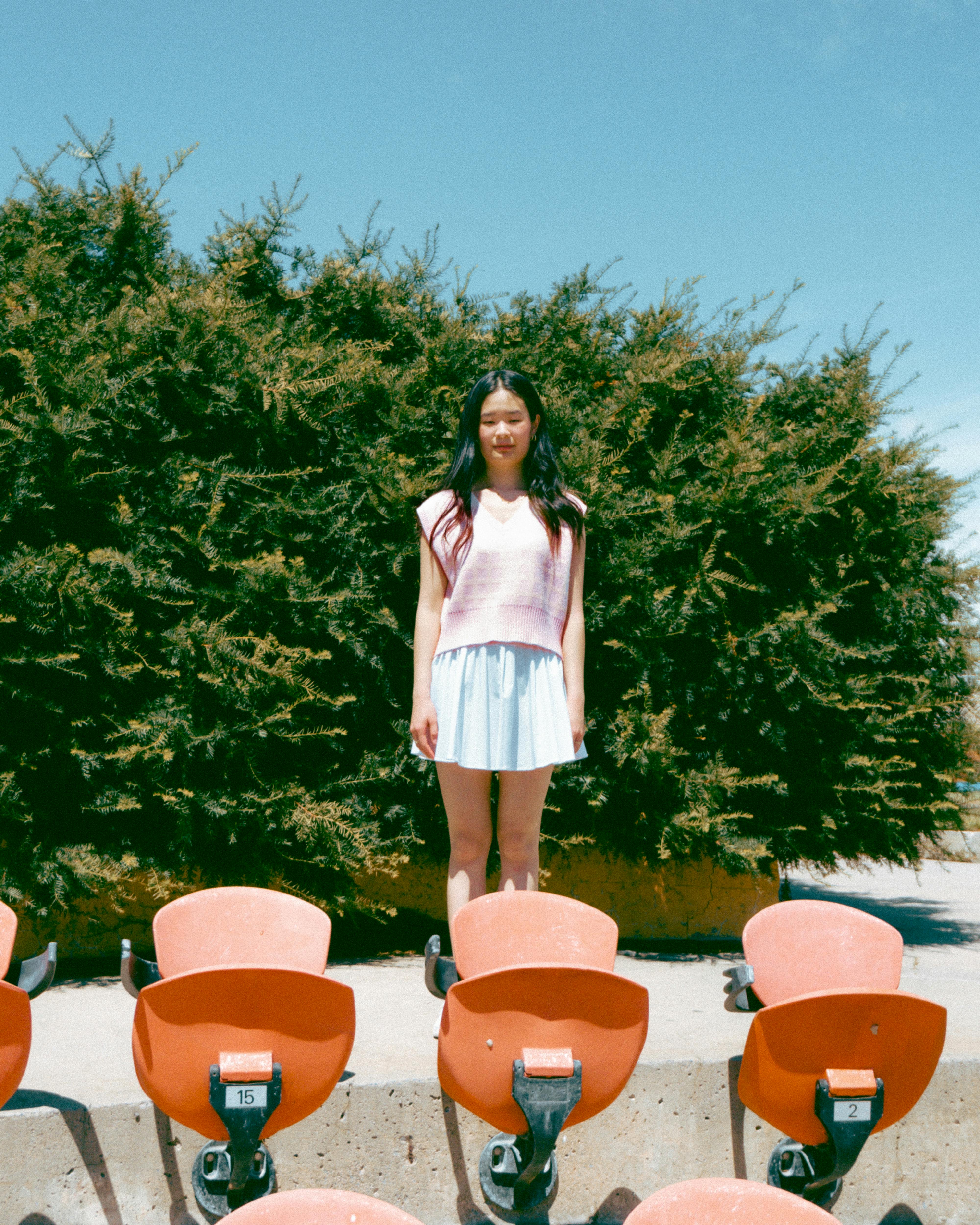 woman standing beside green trees