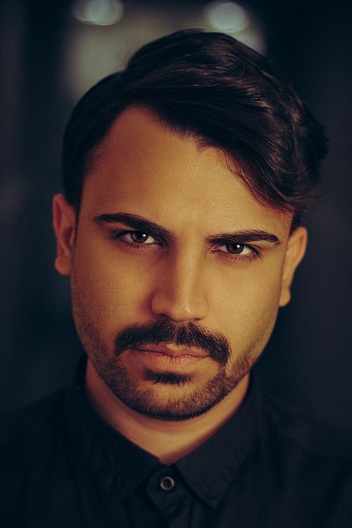 Free Intense portrait of a man with beard and mustache, creating a dramatic mood. Stock Photo