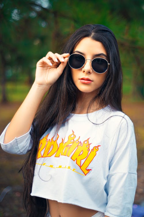 Woman in White Crew Neck T-shirt Wearing Black Sunglasses