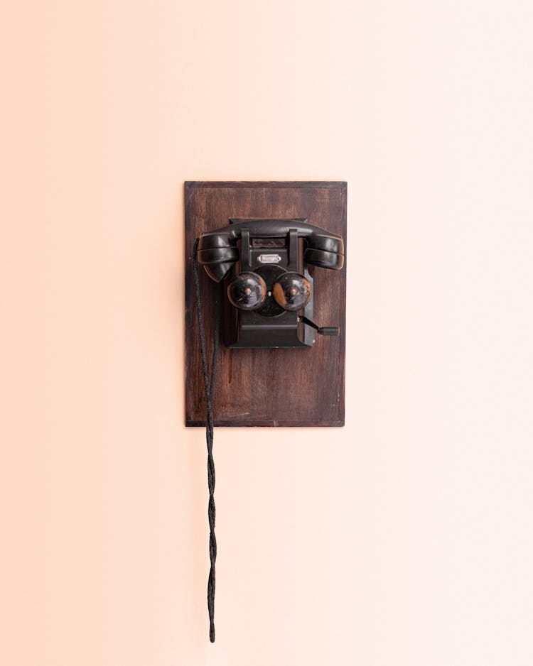 A Black Telephone On The Wall