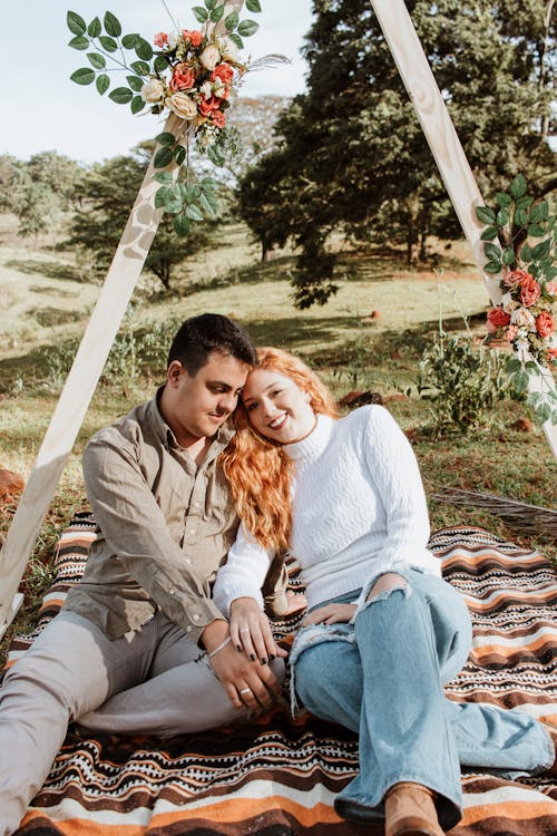 Beautiful Couple Sitting on a Picnic Blanket Together