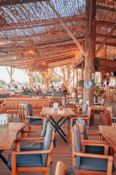 A rustic beachside restaurant with wooden furniture and a cozy ambiance.