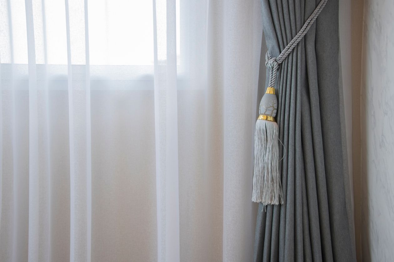 Close-up of a curtain gathered with a tassel tieback