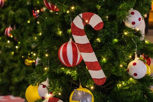 Decorative Christmas tree with candy cane ornaments and festive lights, perfect for holiday cheer.