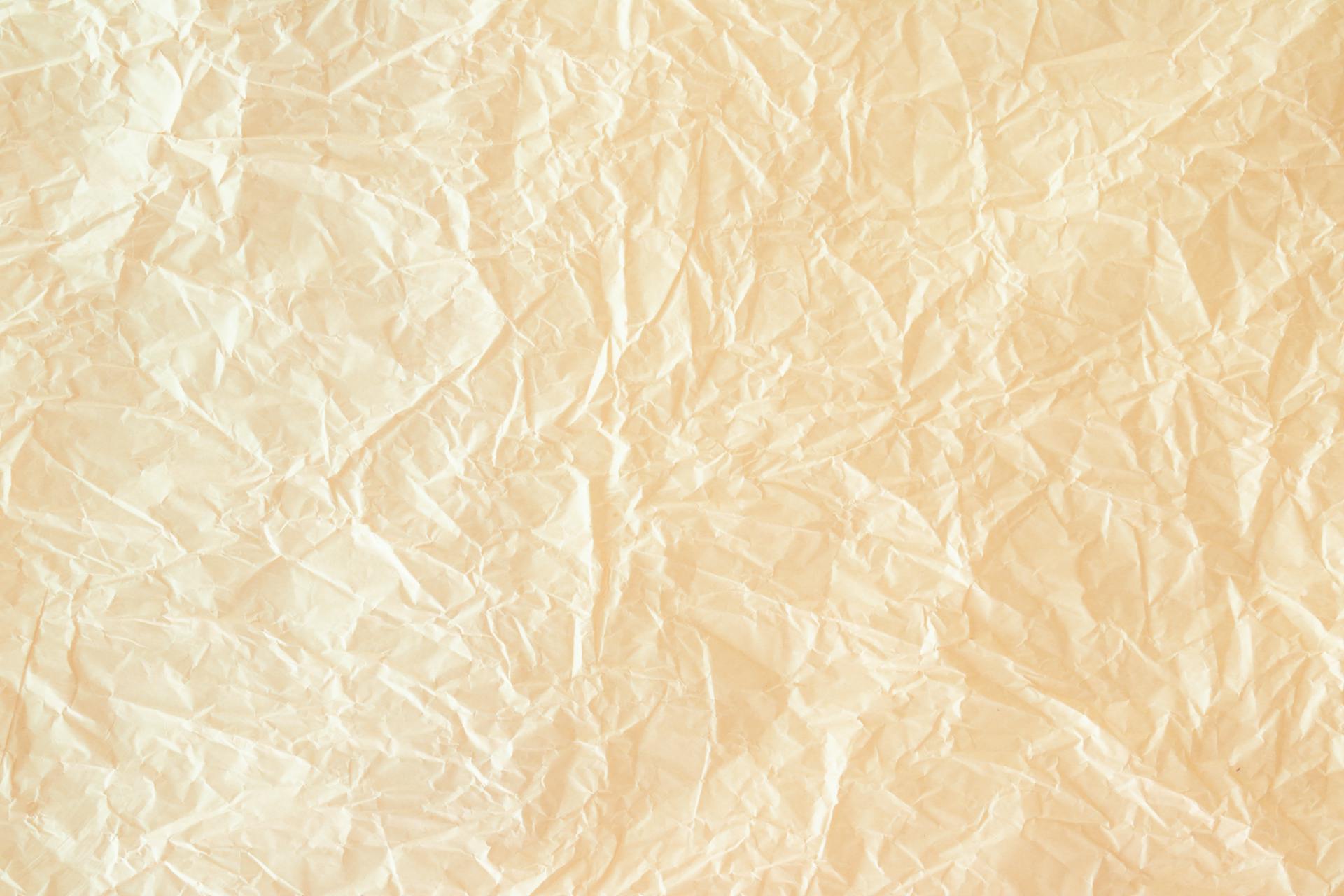 High-resolution image of crinkled yellow paper texture ideal for design projects.