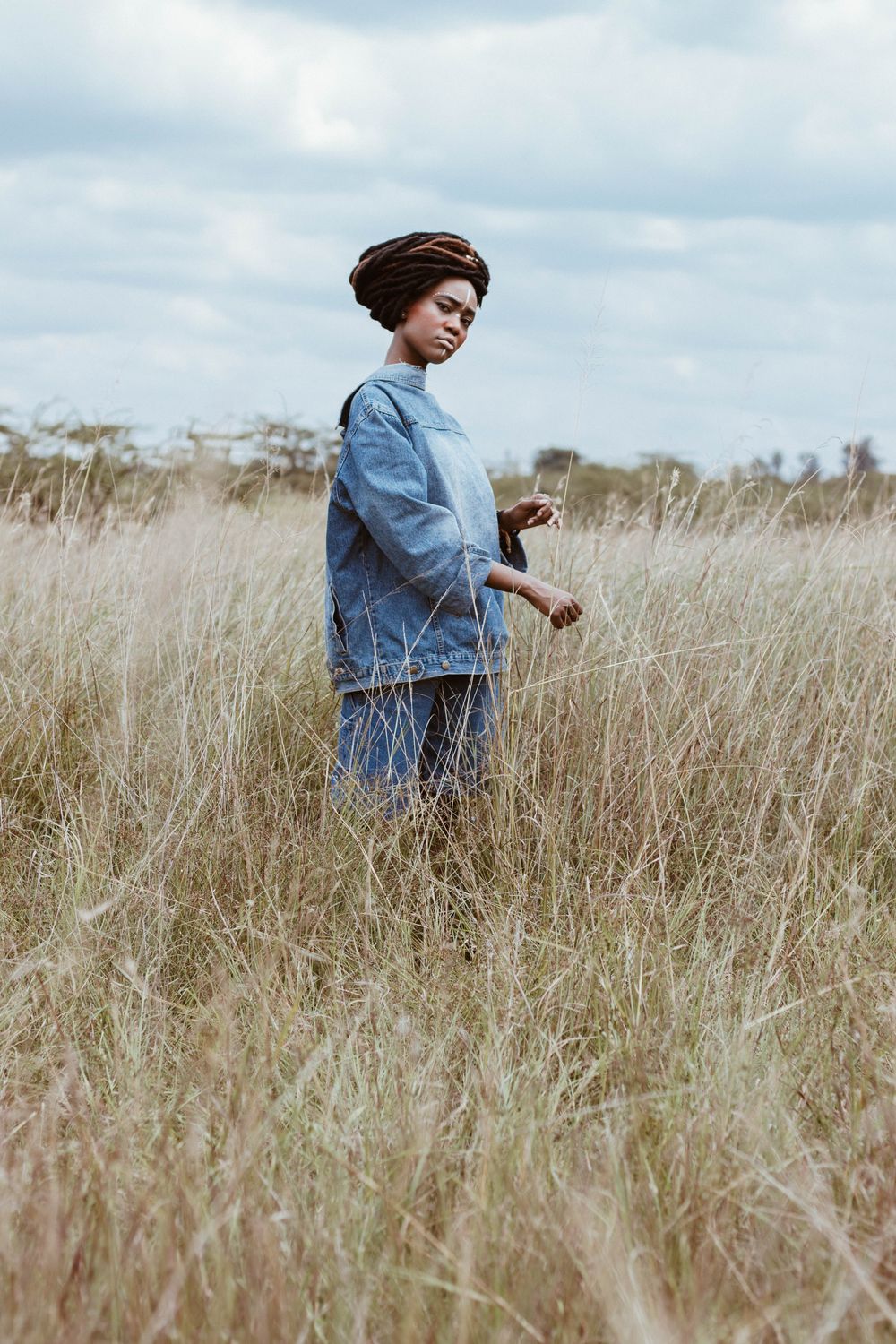 Woman Standing on Green Grass Field · Free Stock Photo