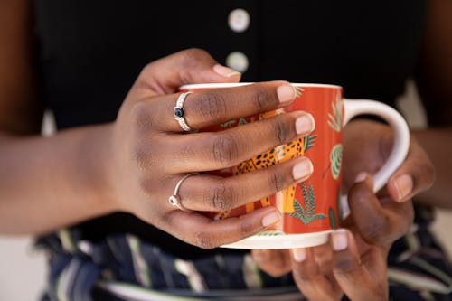 Free Woman Holding Coffee Cup with Rings on Stock Photo