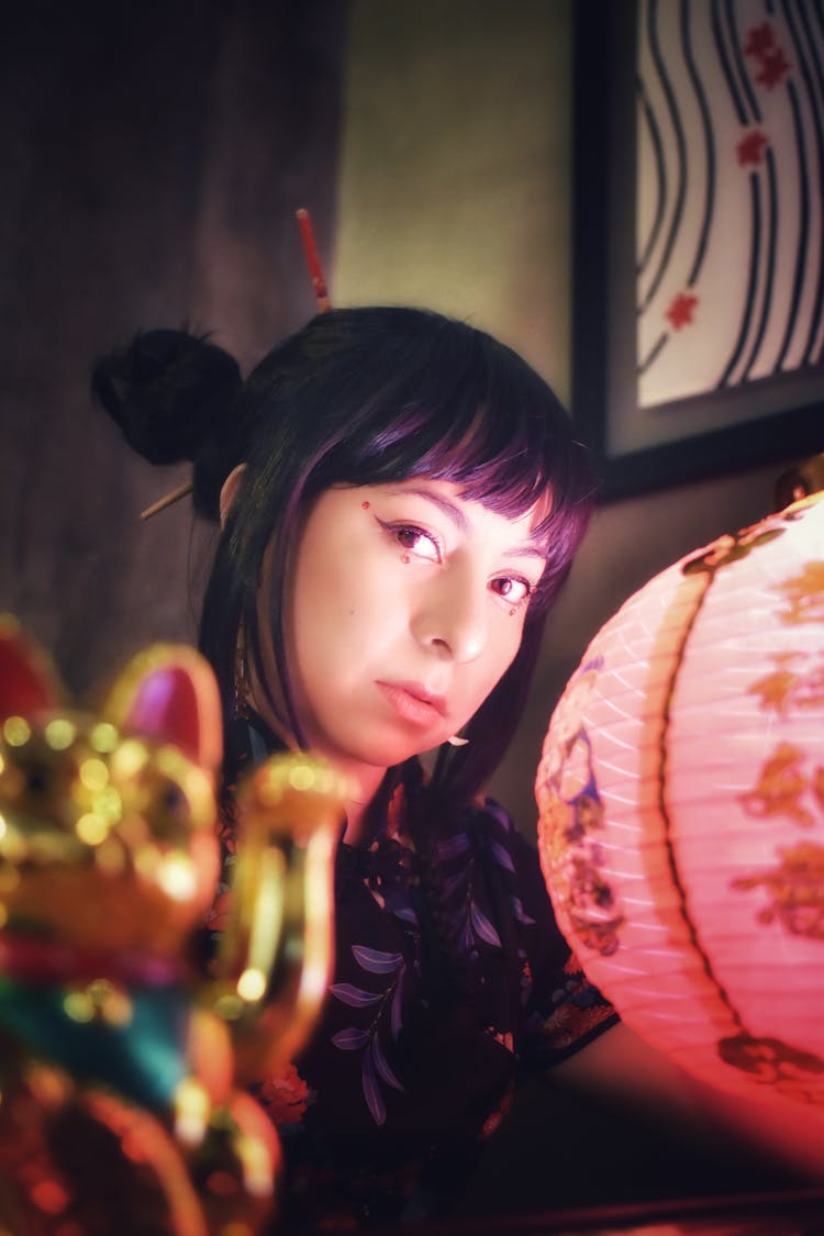 Photo Of A Woman With Bangs Near A Red Lantern