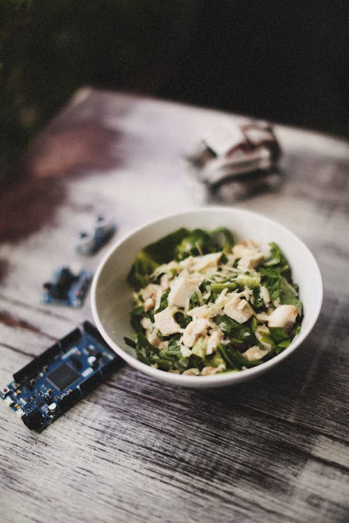 A Bowl of Healthy Green Salad on a Wooden Table