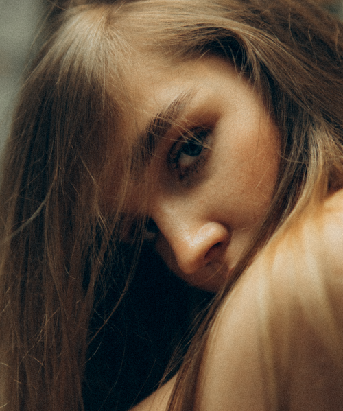 Free Intimate close-up portrait of a woman with tousled blonde hair. Stock Photo