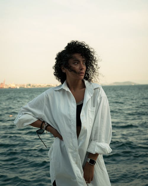 A Portrait of a Woman Wearing a White Oversized Dress Shirt