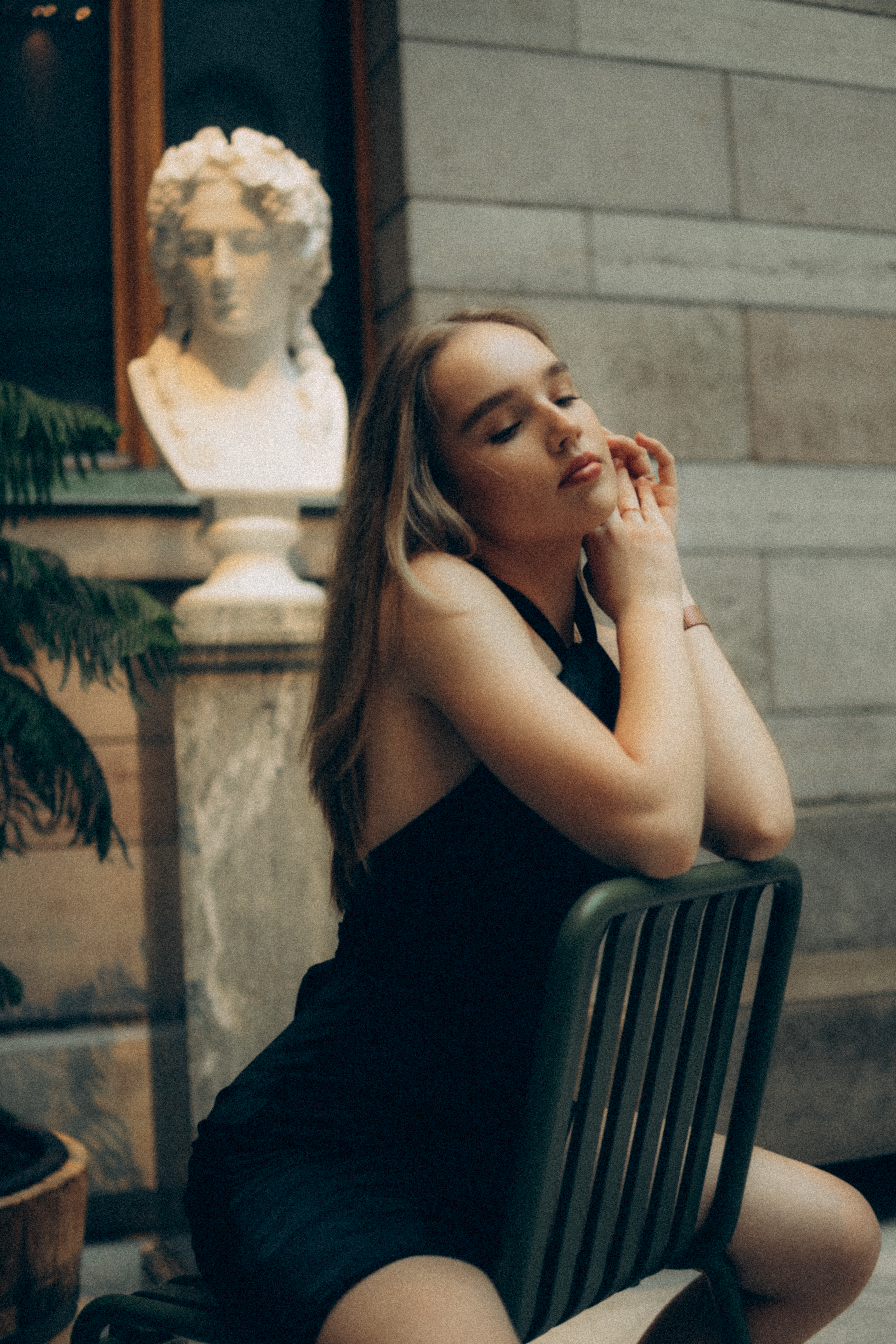 A Woman in Black Dress Sitting on Black Chair · Free Stock Photo