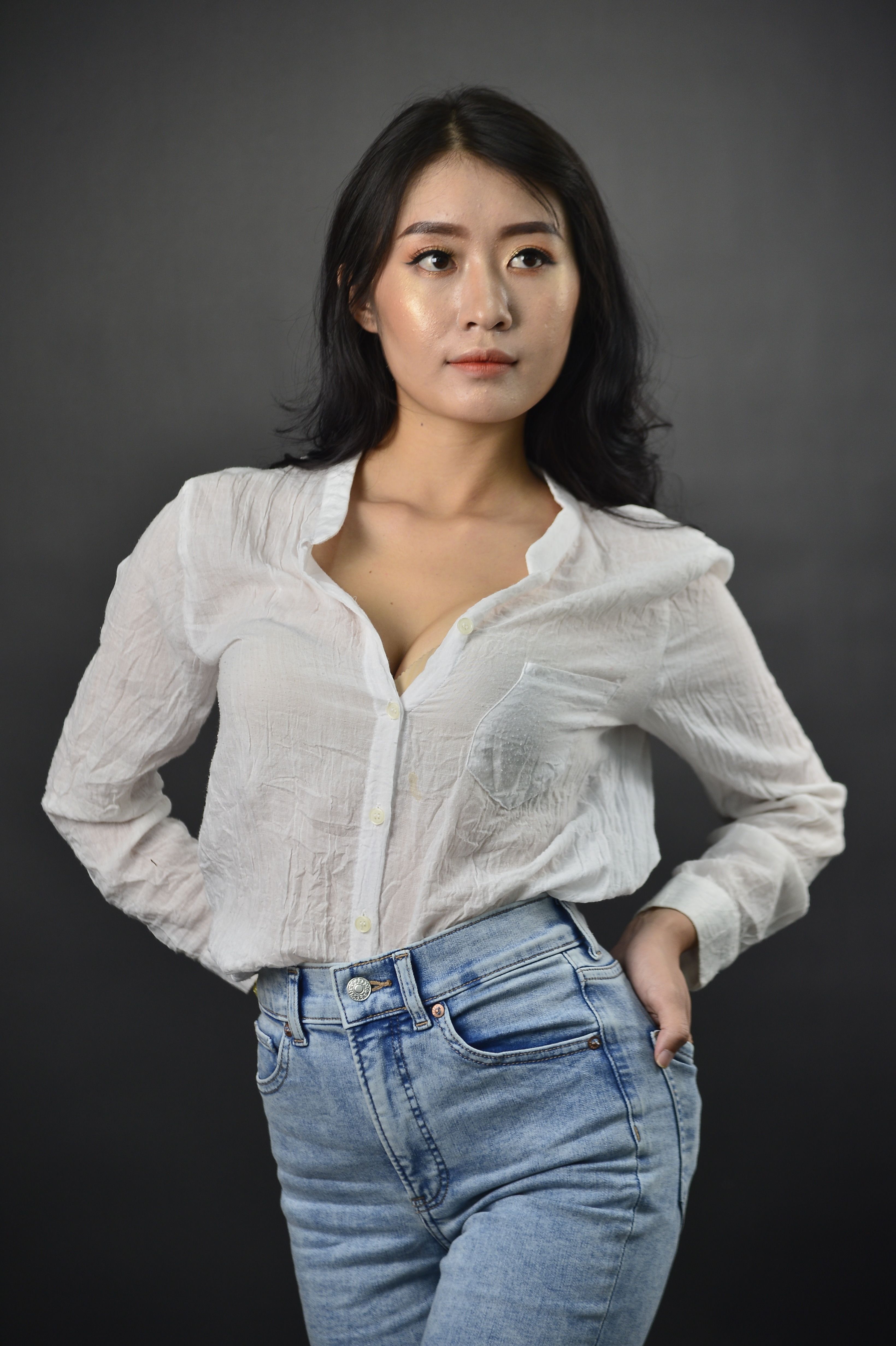 Photo of Woman in White Long Sleeve Shirt Posing · Free Stock Photo