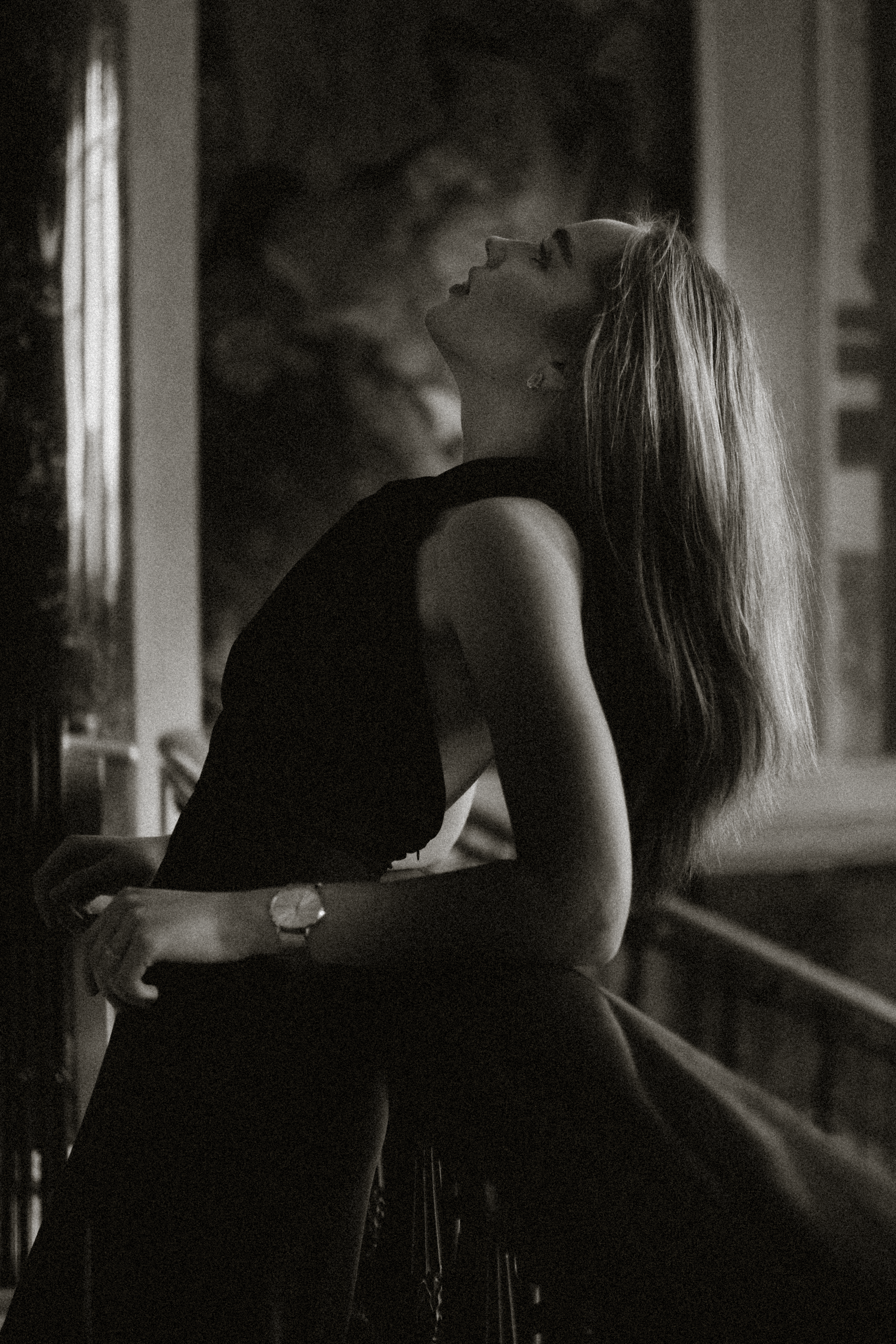 A Woman in Black Sleeveless Dress Leaning on a Railing · Free Stock Photo