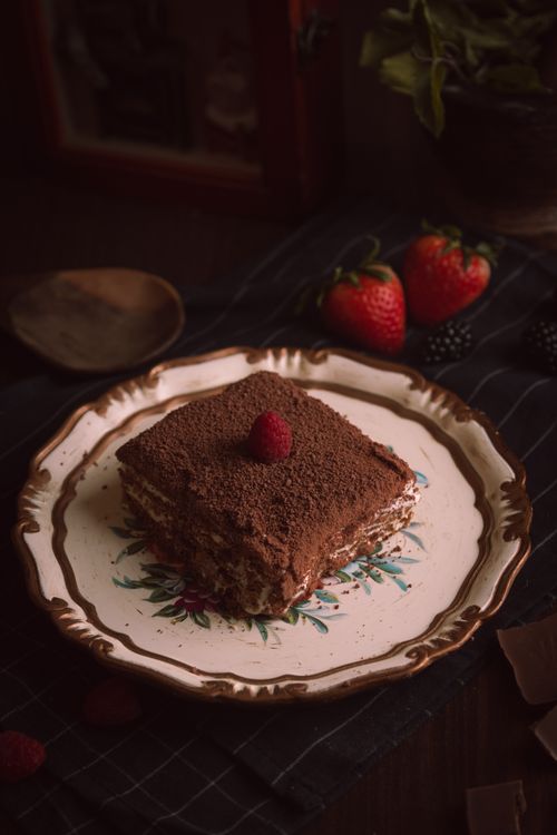 Free Delicious chocolate cake with raspberries on a vintage plate, perfect for indulgent dessert moments. Stock Photo