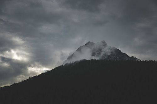 Free Moody landscape of a fog-covered mountain peak in Trentino-South Tyrol, Italy. Stock Photo