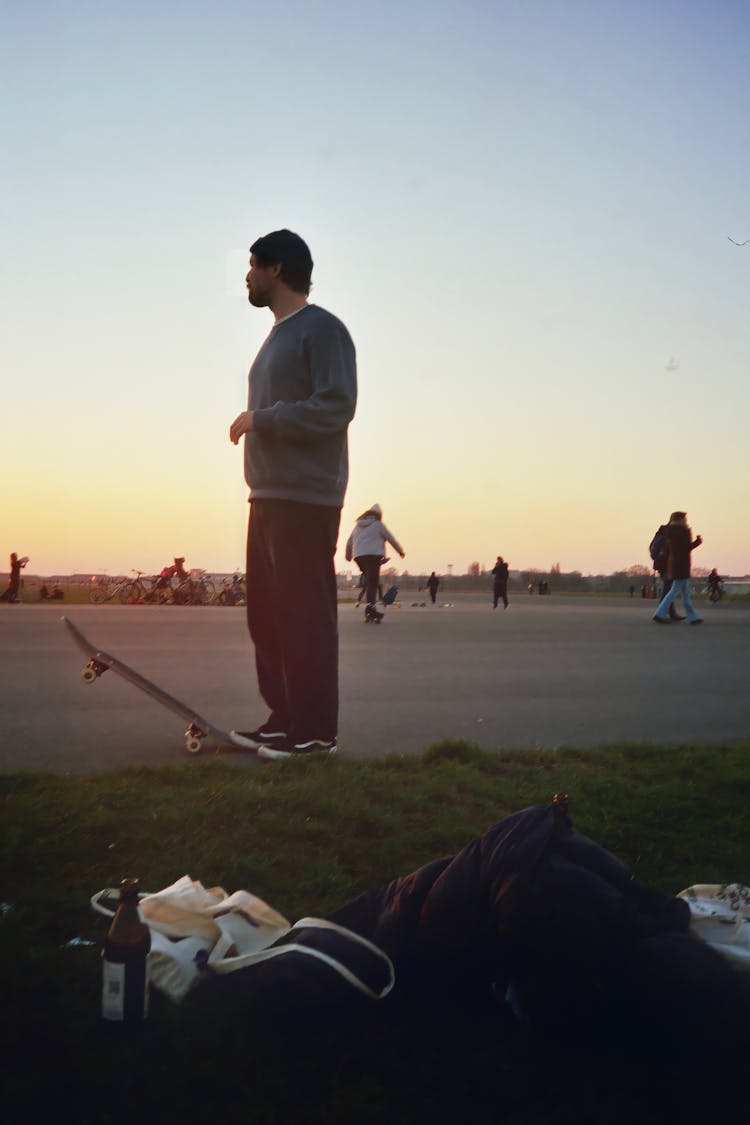 A Man Stepping On A Skateboard