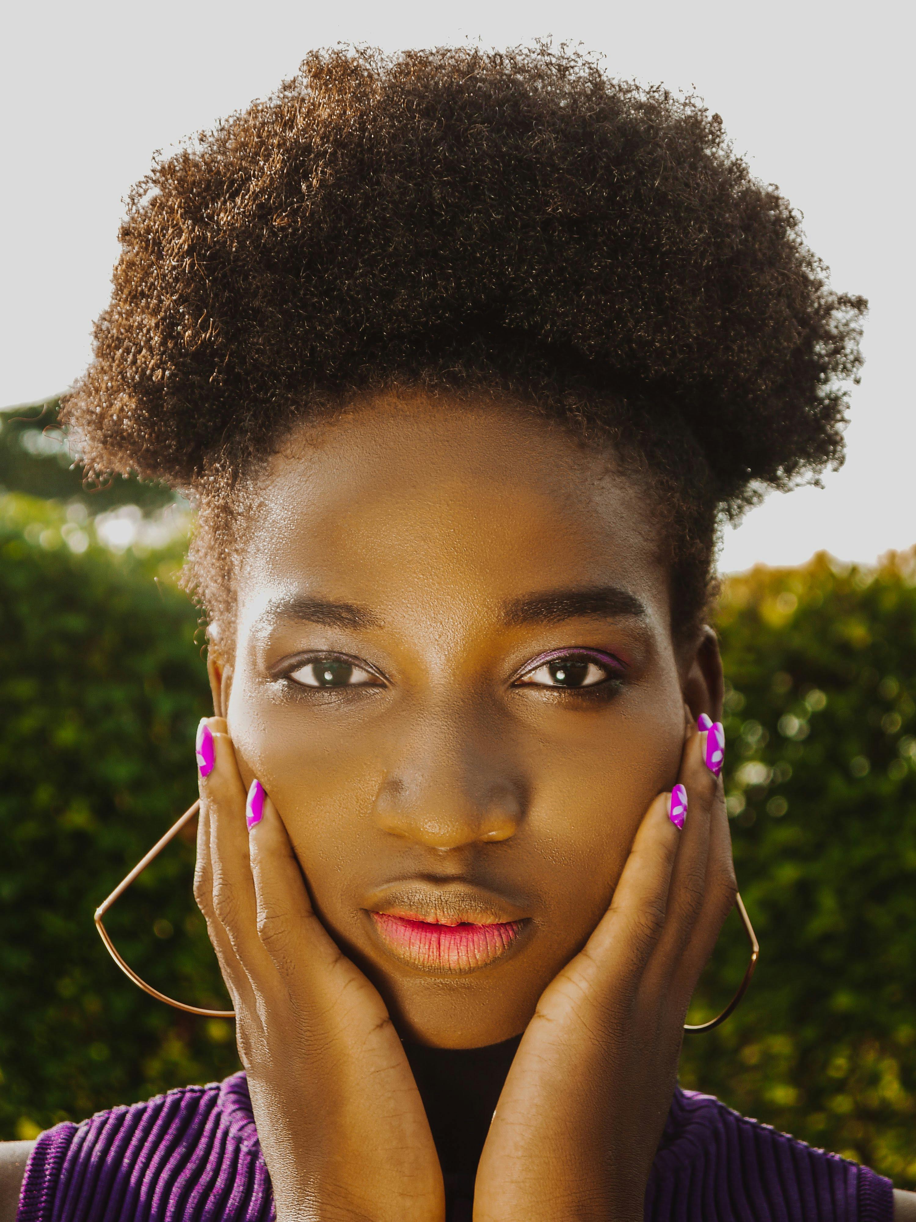 Woman with Curly Hair Leaning on a Railing with One Hand in Hair · Free ...