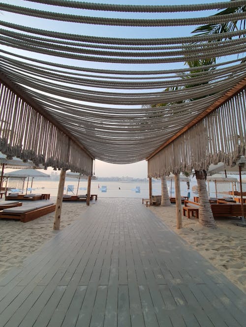 A Wooden Pathway in a Resort going towards the Shore