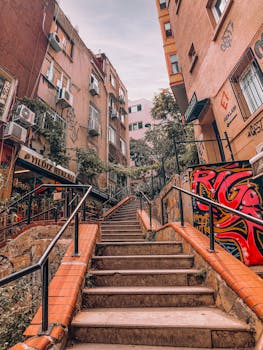 Vibrant city staircase with graffiti art and surrounding buildings.