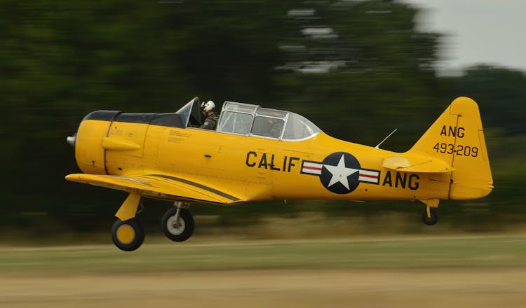 A Person Taking Off With A Yellow Airplane