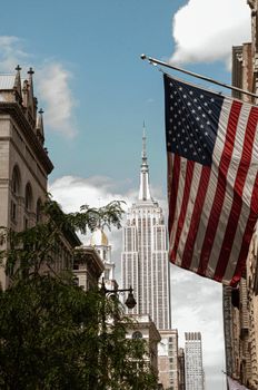 Empire State Building framed by an American flag in New York City.