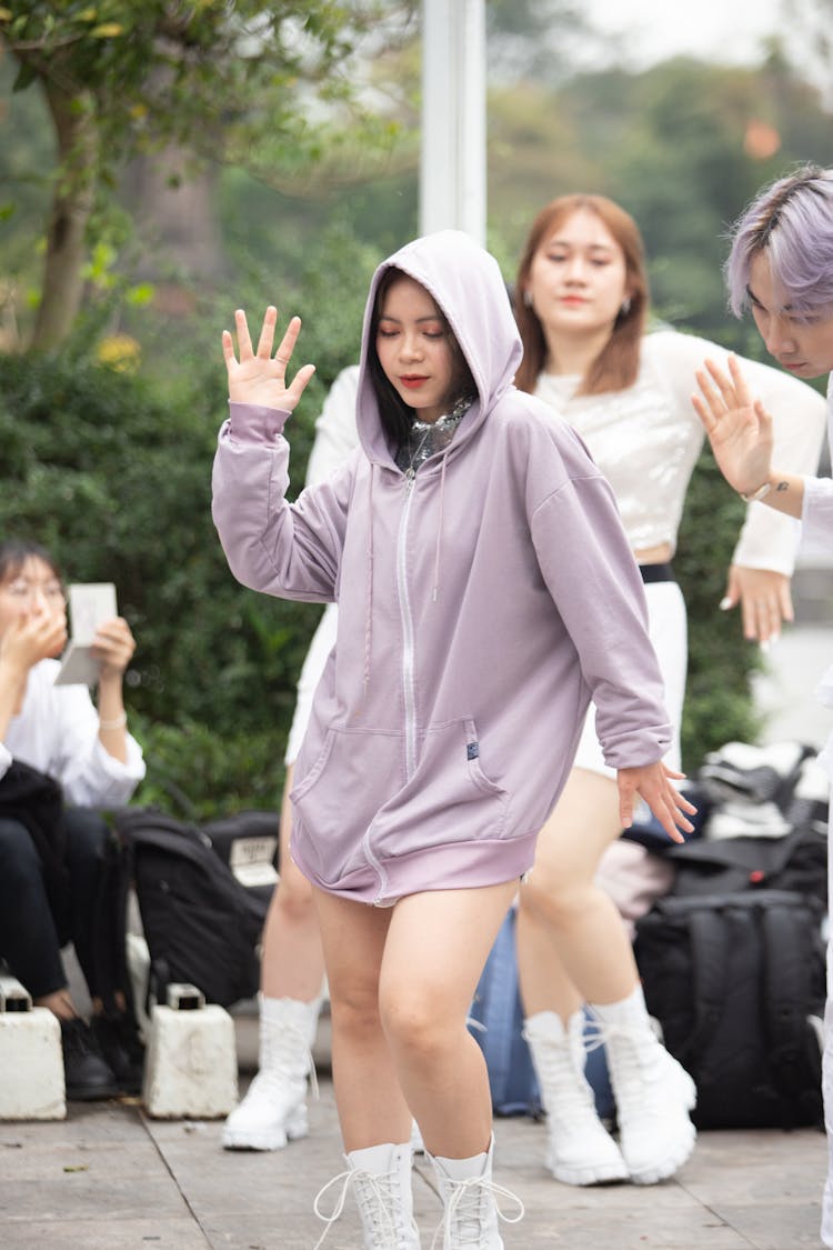 A Woman In A Hoodie Dancing 