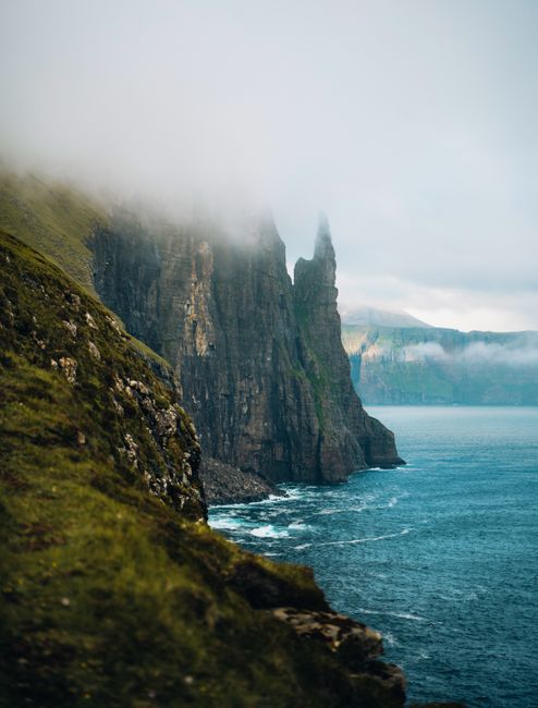 Explore the stunning fog-covered cliffs along the seashore of the breathtaking Faroe Islands.
