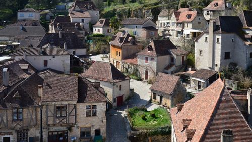 Free Scenic view of rustic European village with stone houses and tiled roofs under daylight. Stock Photo