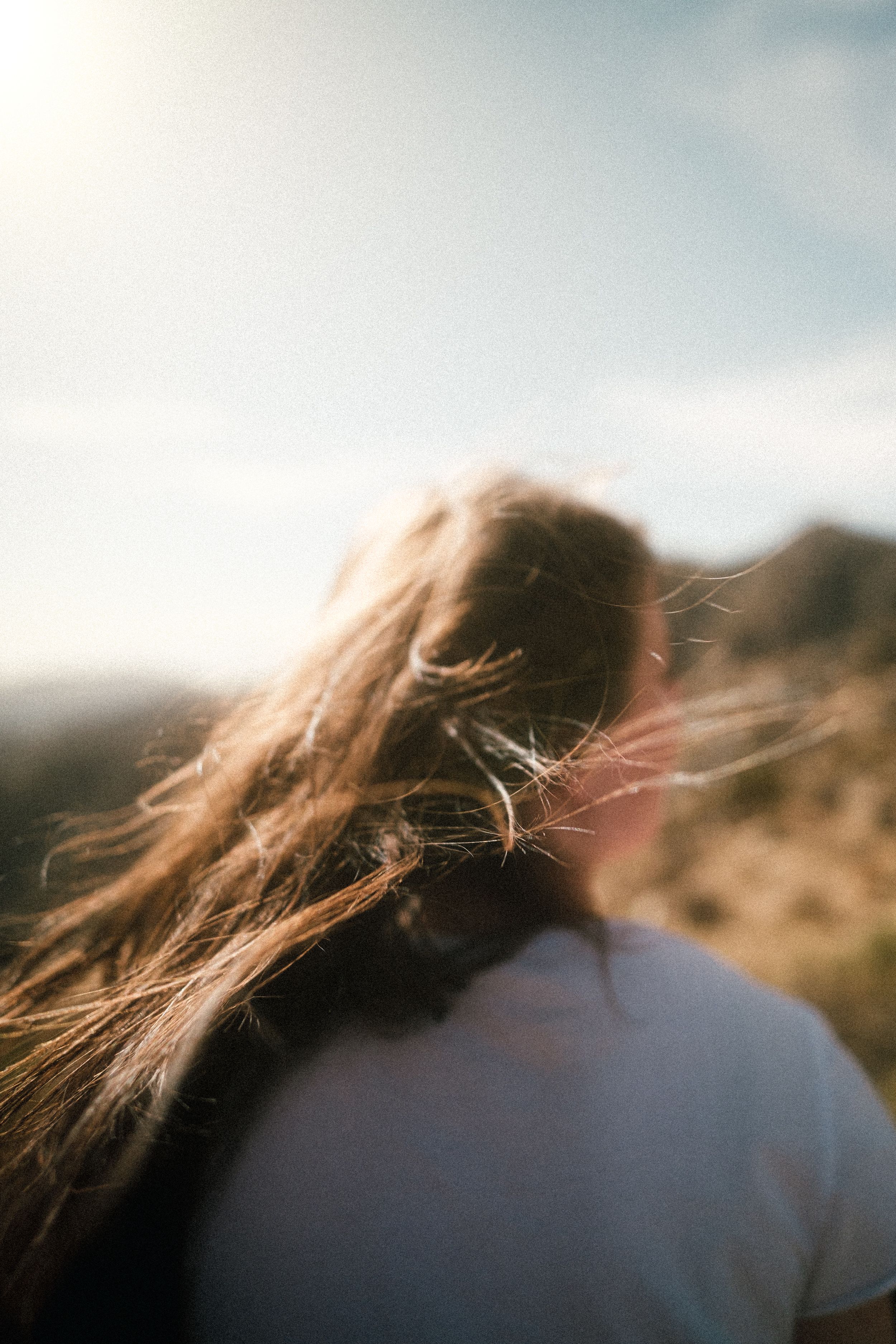 Woman in White Shirt Standing on Brown Grass Field · Free Stock Photo