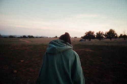 A Woman in a Hoodie Sweater at an Open Field