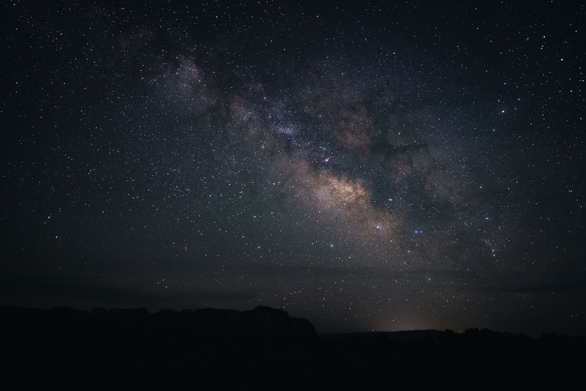Stunning view of the Milky Way galaxy illuminating the night sky over Southern Utah's desert landscape.