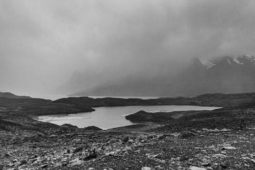 Grayscale Photo of a Lake in the Mountain