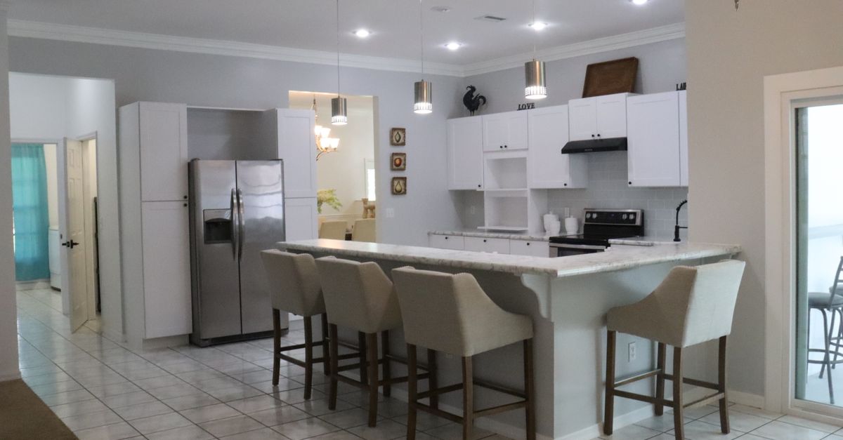 Spacious kitchen interior featuring a marble countertop and contemporary design elements.
