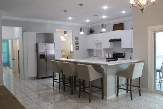 Spacious kitchen interior featuring a marble countertop and contemporary design elements.