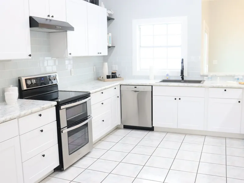 Bright, spacious kitchen with white cabinets, appliances and natural light Bright, spacious kitchen with white cabinets, appliances and natural light