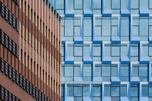 Free Aesthetic juxtaposition of modern glass and brick facades, capturing urban architecture. Stock Photo