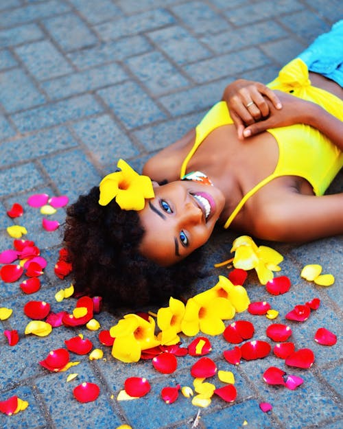 A Woman in Yellow Top Lying on Bricks 