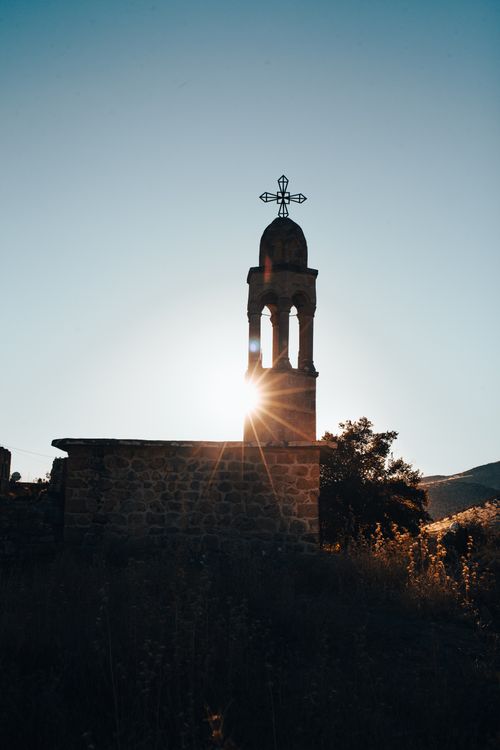 Free A striking silhouette of an ancient chapel at sunrise in Dereiçi, Mardin, Turkey. Stock Photo