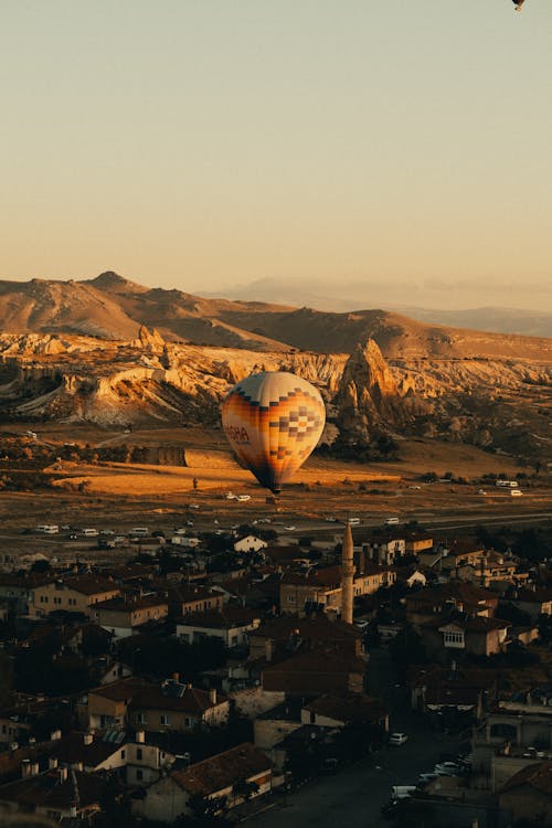 Hot Air Balloon Flying over a City